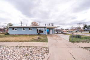 Single story home with a carport and driveway