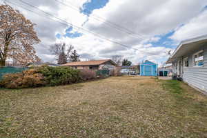 Fenced yard with a shed
