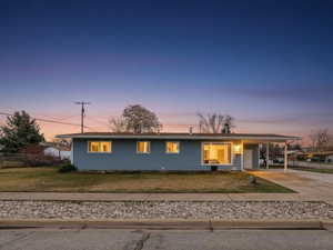 View of front of property featuring concrete driveway and a porch