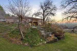 View of grassy yard featuring a patio