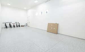 Miscellaneous room featuring speckle patterned floor and baseboards