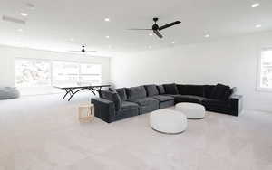 Living area featuring light colored carpet and recessed lighting
