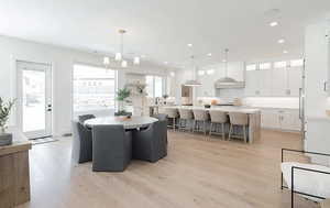 Dining room featuring light wood-style flooring and a chandelier