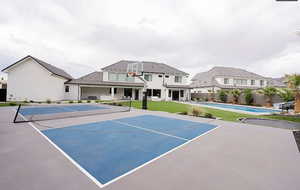 View of tennis court with a patio area, basketball court, and a residential view