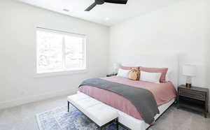 Carpeted bedroom with a ceiling fan and recessed lighting