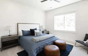 Carpeted bedroom featuring ceiling fan and baseboards