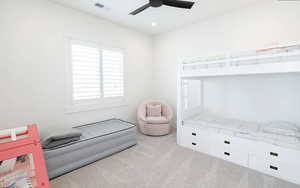 Bedroom featuring light colored carpet, a ceiling fan, and recessed lighting