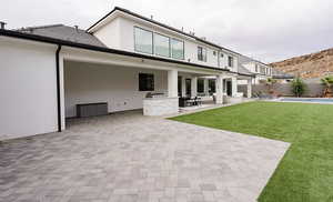 Rear view of property featuring a patio and stucco siding