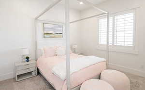 Carpeted bedroom featuring baseboards