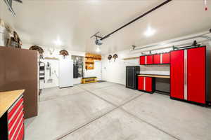 Garage with water heater and freestanding refrigerator