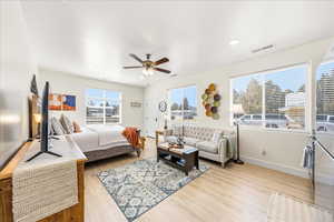 Bedroom with light wood finished floors and a ceiling fan