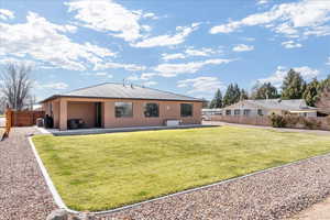 Back of property featuring a patio, stucco siding, and a metal roof