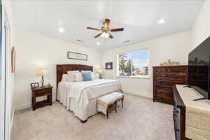 Bedroom featuring light carpet, a ceiling fan, and recessed lighting