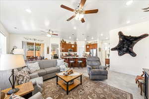 Living room with recessed lighting and ceiling fan