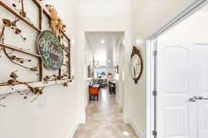 Hall featuring baseboards and recessed lighting