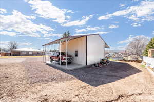 View of outbuilding featuring a carport