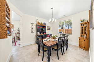 Dining room with suspended lighting and baseboards