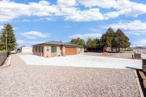 View of front of house featuring concrete driveway, stucco siding, stone siding, and a garage