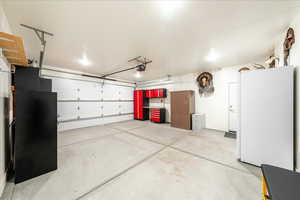 Garage featuring freestanding refrigerator