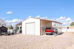 View of outbuilding featuring driveway