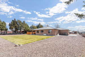 Rear view of property featuring a fenced backyard, a metal roof, and stucco siding