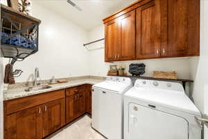 Laundry area featuring washing machine and dryer and cabinet space