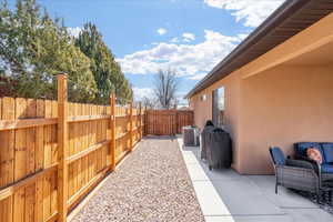 Fenced backyard featuring a patio