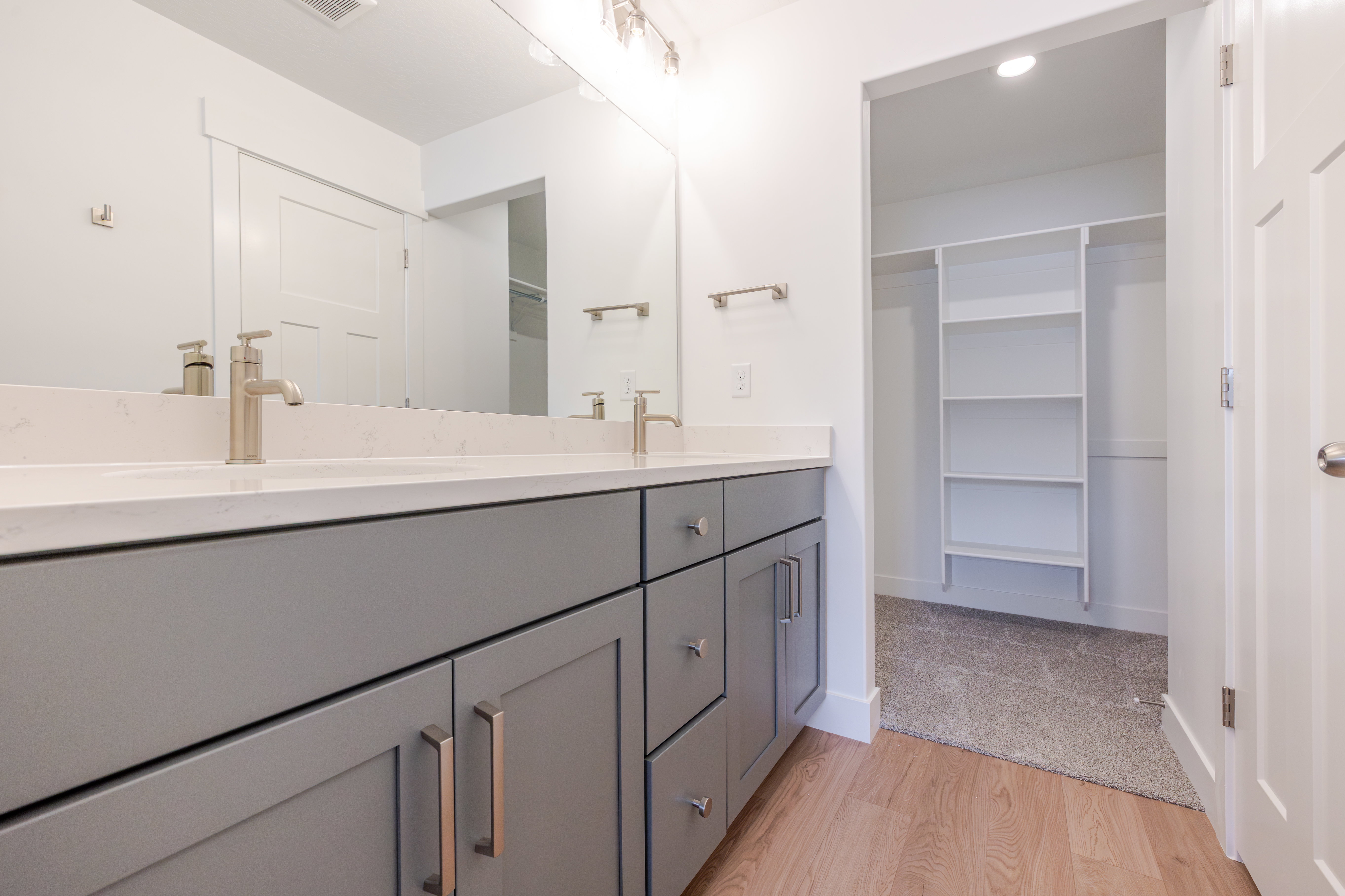 Double vanity with gray cabinetry, brushed nickel hardware, and a quartz-finish countertop