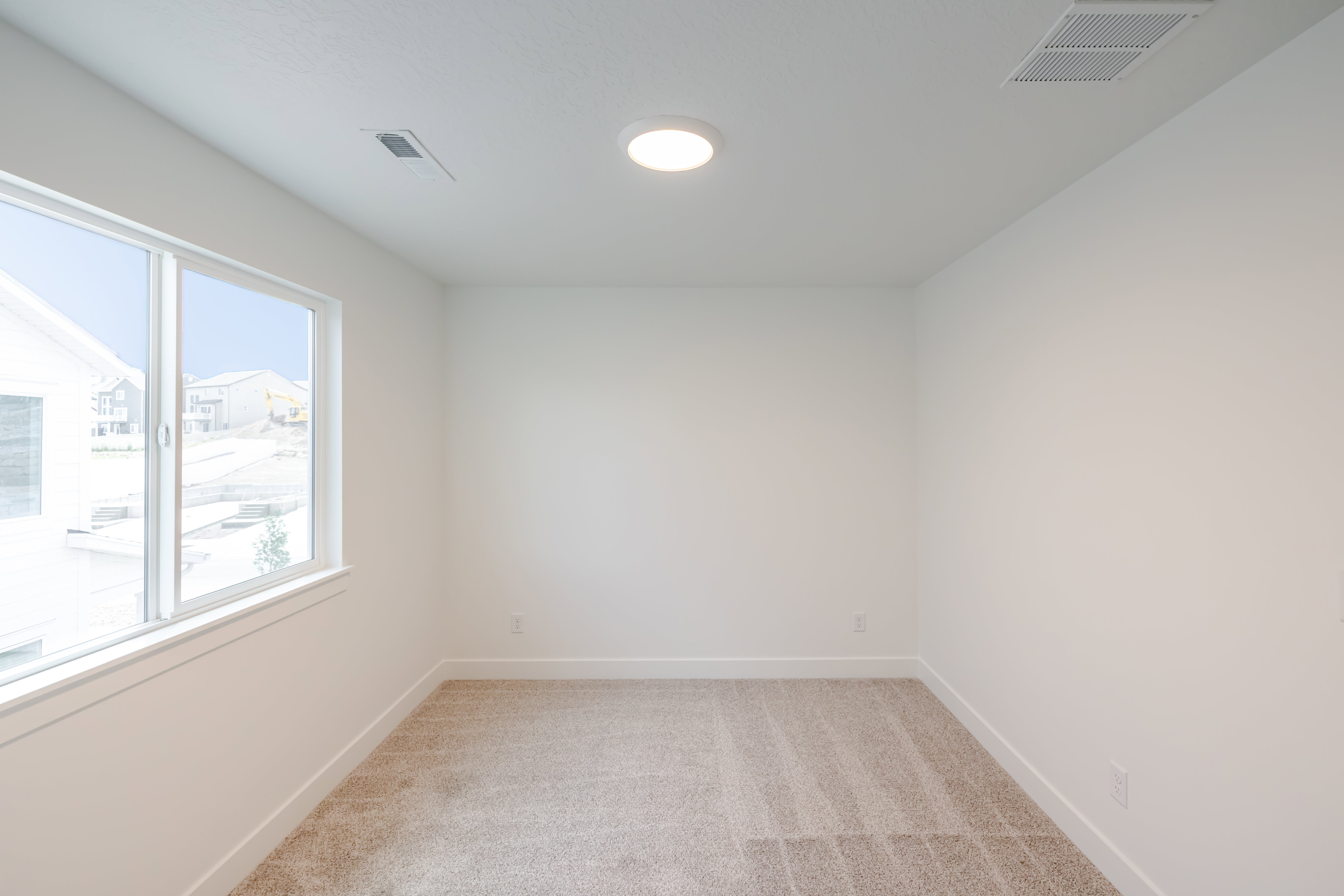 Bright room with neutral carpeting and white walls