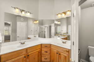Bathroom with double vanity and a shower stall