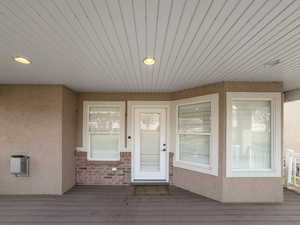 Entrance to property featuring stucco siding and heating unit
