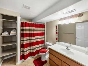 Full bathroom with vanity, a shower with curtain, and a closet
