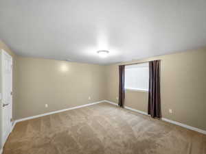 Unfurnished room with light carpet