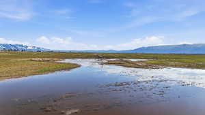 Water view featuring rural landscape and a mountainous background