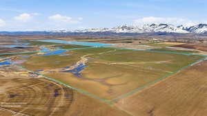 Overview of rural landscape with property boundaries highlighted and a water and mountain view