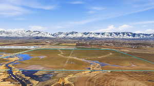 Aerial view of sparsely populated area with property boundaries highlighted and a mountain backdrop