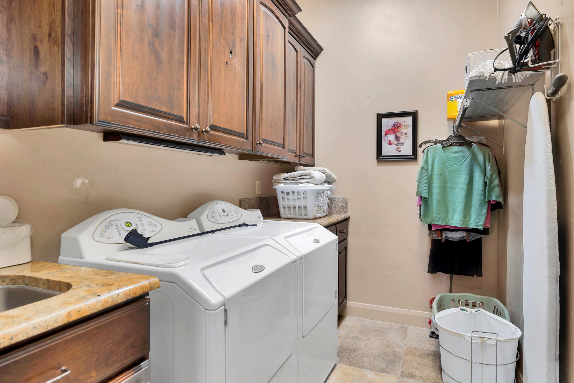 Laundry room with cabinet space and washer and clothes dryer
