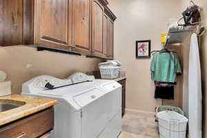 Laundry room with cabinet space and washer and clothes dryer