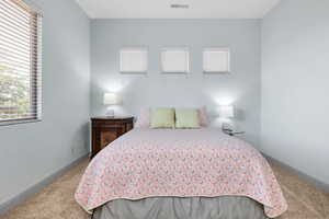 Carpeted bedroom featuring baseboards