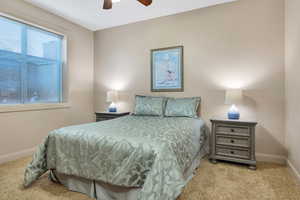 Bedroom featuring light carpet and a ceiling fan