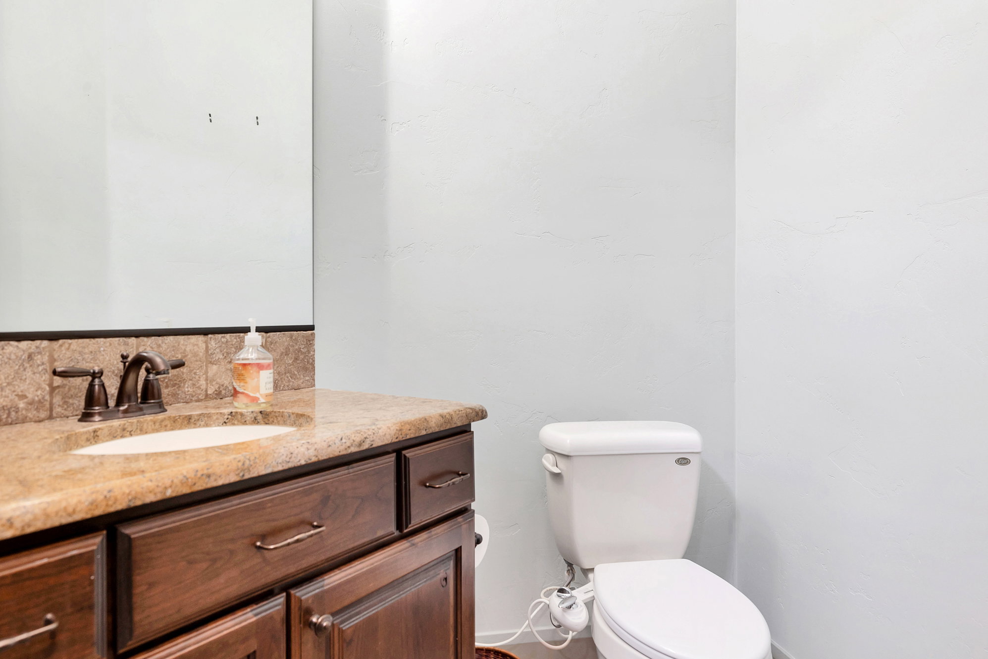 Half bathroom with vanity and toilet