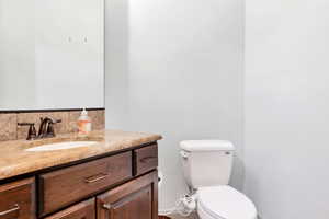 Half bathroom with vanity and toilet