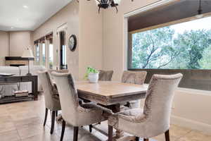 Dining area featuring light tile patterned floors and hanging lights