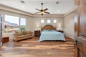 Bedroom with a mountain view, wood finished floors, a ceiling fan, and recessed lighting