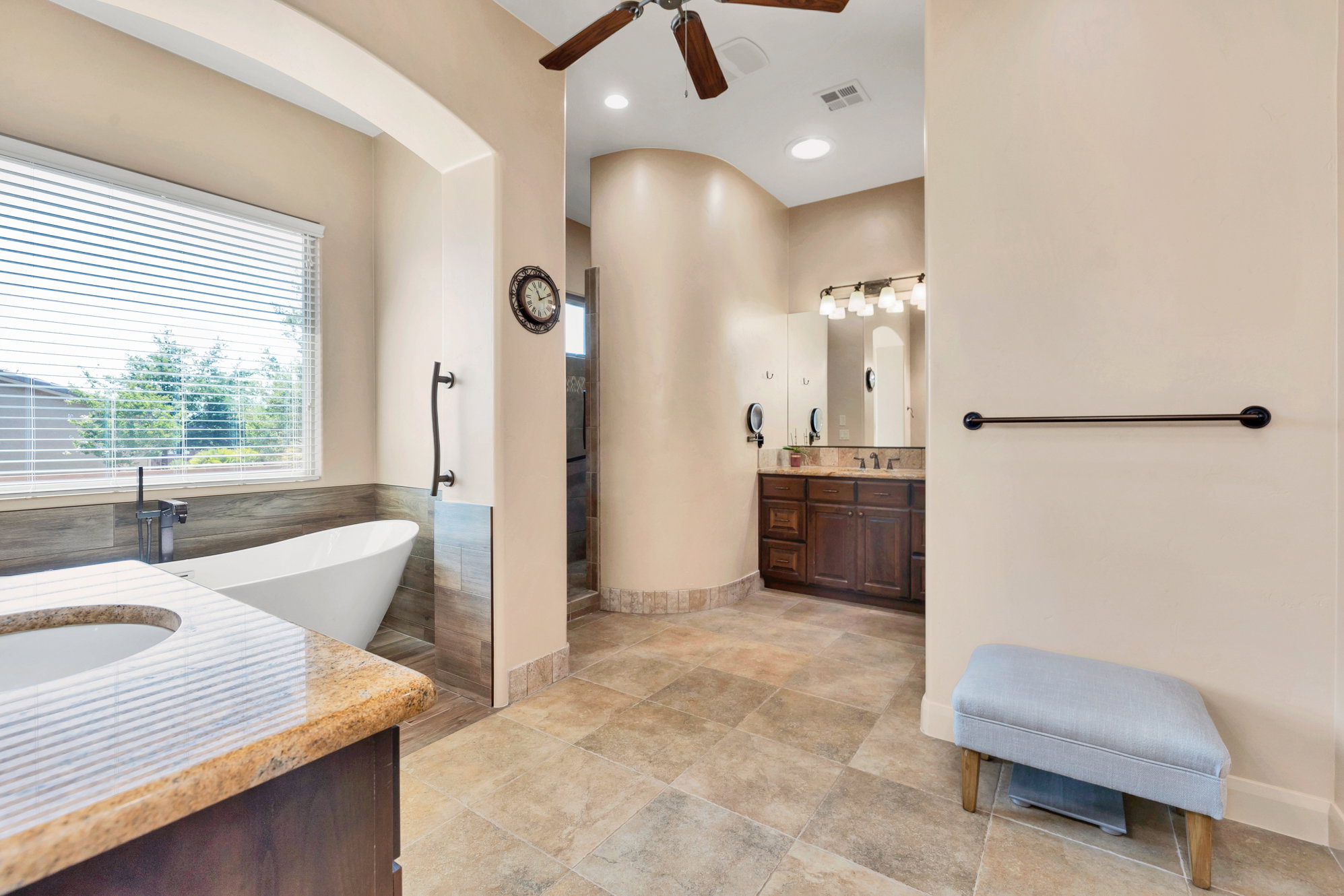 Bathroom featuring vanity, a ceiling fan, a soaking tub, and recessed lighting