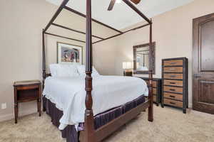 Bedroom with light carpet and a ceiling fan