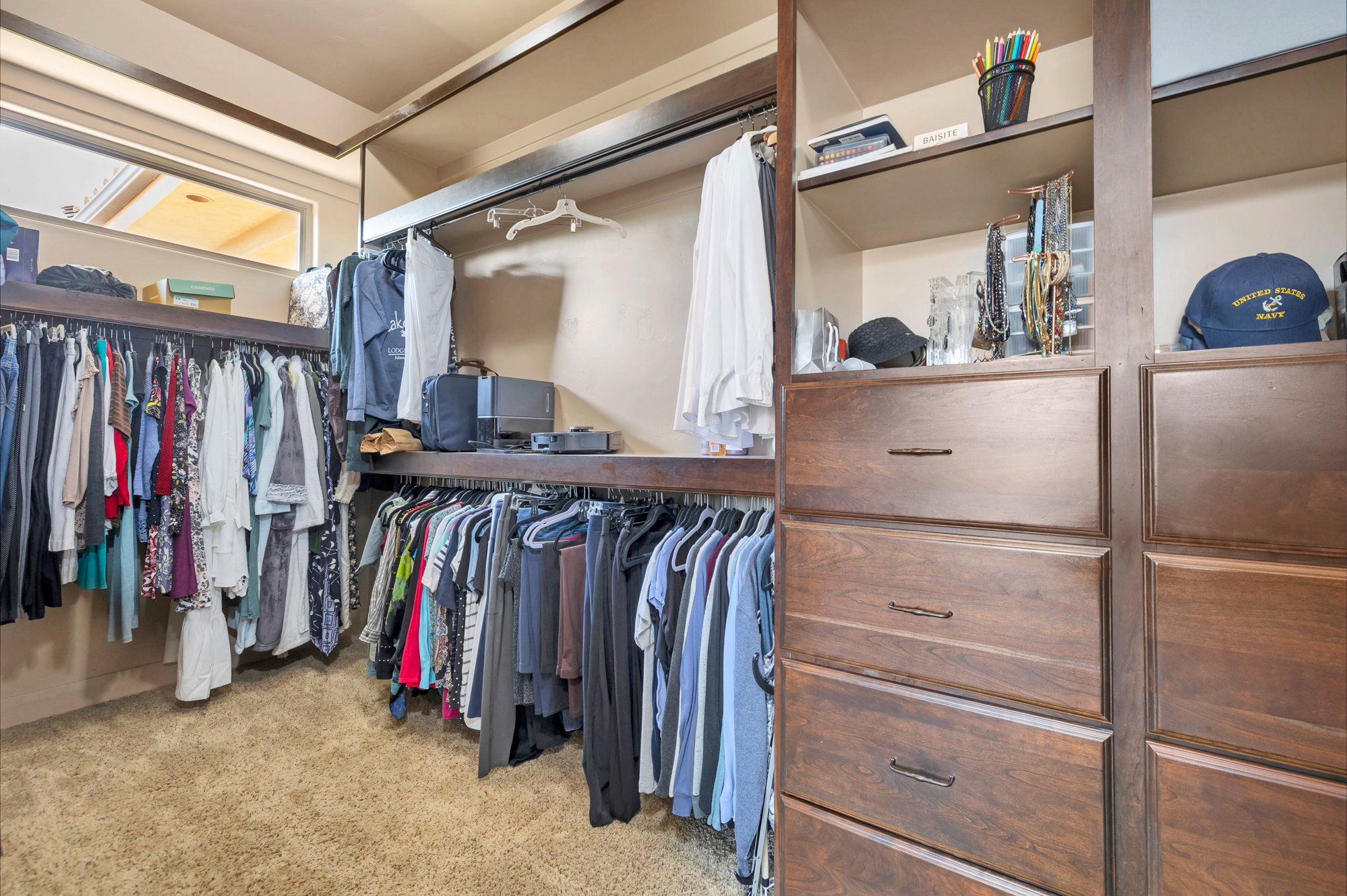 Walk in closet with light carpet