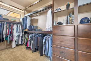 Walk in closet with light carpet