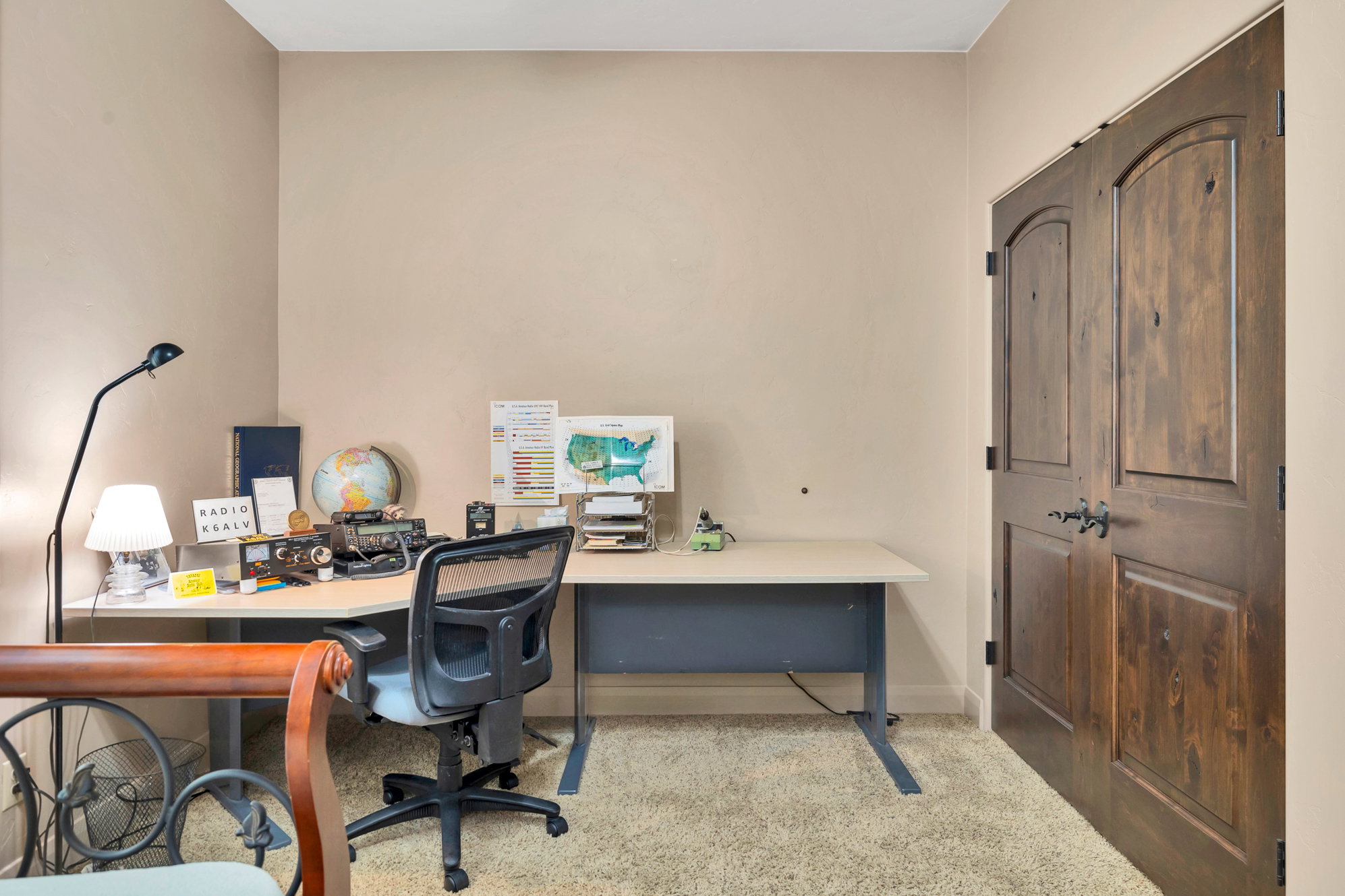 Office space featuring light colored carpet and baseboards