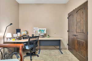 Office space featuring light colored carpet and baseboards